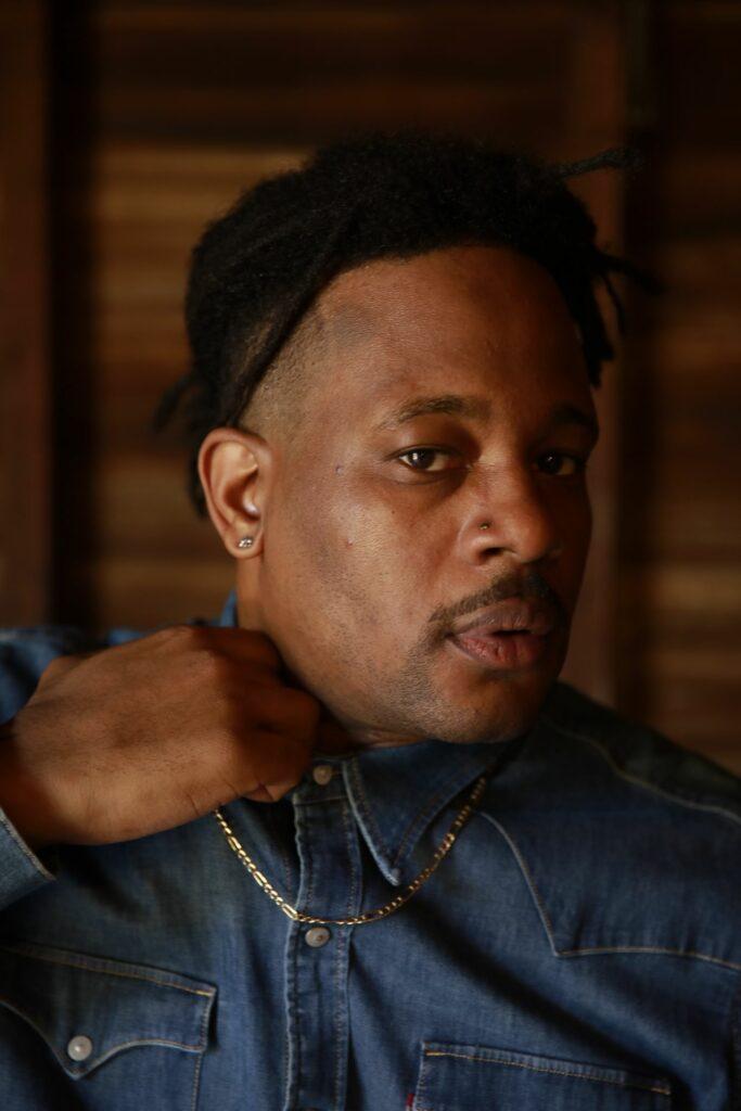 https://d1ct6yhiw4gple.cloudfront.net/wp-content/uploads/2025/04/Open-Mike-Eagle-press-shot-by-Kim-Newmoney-683x1024.jpeg